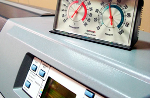 A controlled environment is key for high quality printed graphics. A printer control station is shown with a guage above measuring humidity and more. 