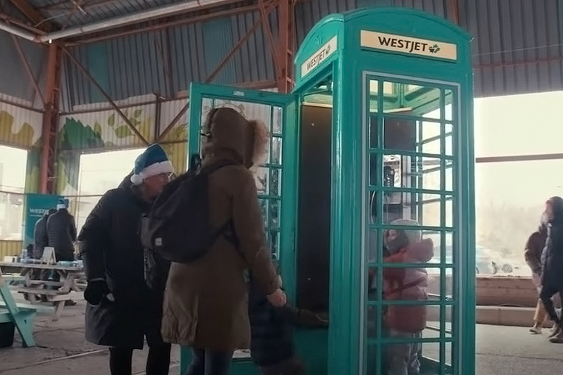 teal london-style phone booth with the Westjet brand for a christmas experiential marketing event in Calgary 