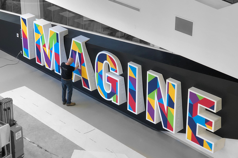 custom fabrication for a branded donor wall that spells out "Imagination"environment in Edmonton Alberta