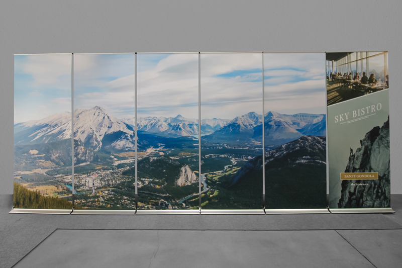 a row of 6 retractable banner stands that showcase one image of Banff National Park.