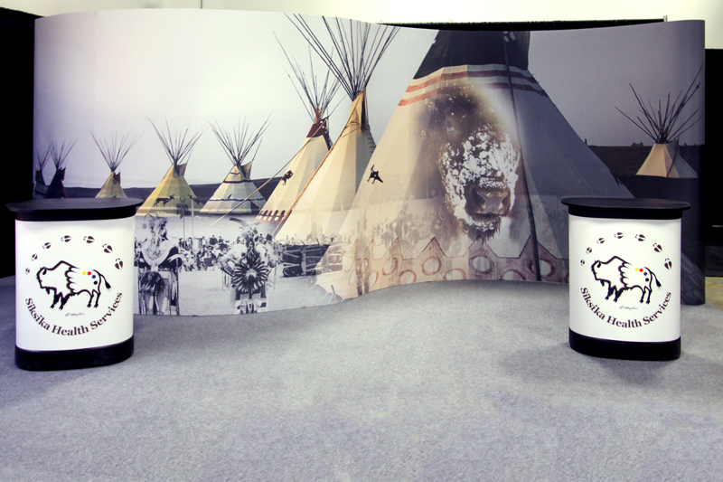 portable pop-up trade show display with a curved "S" shape for an Albertan First Nations group. 