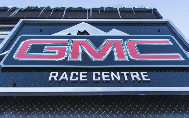 dimensional sign and 3D lettering for GMC at the front of the hut above the entrance, along with textured tread-like wall cladding