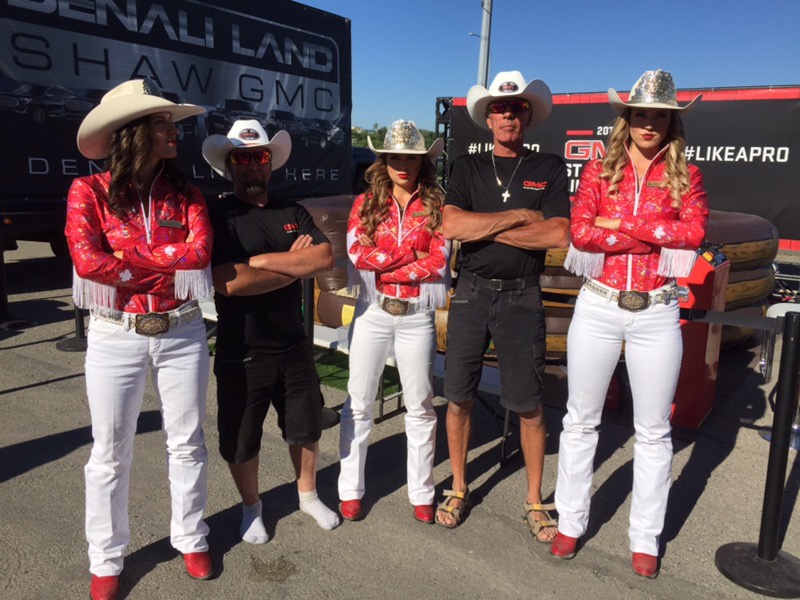 3 cowgirls and 2 exhibit studio staff members in western wear for an event during the Calgary Stampede