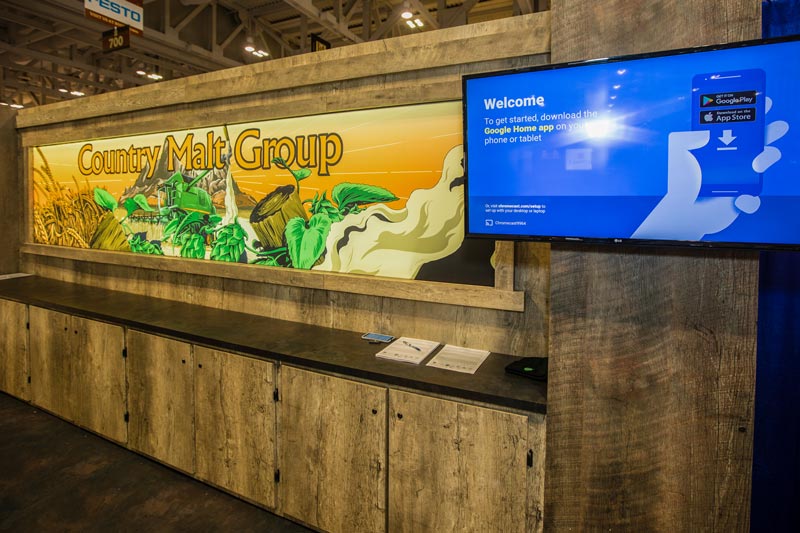 close up of the 10x20 trade show booth with a large illustrated back wall panel showcasing Canadian agriculture. 