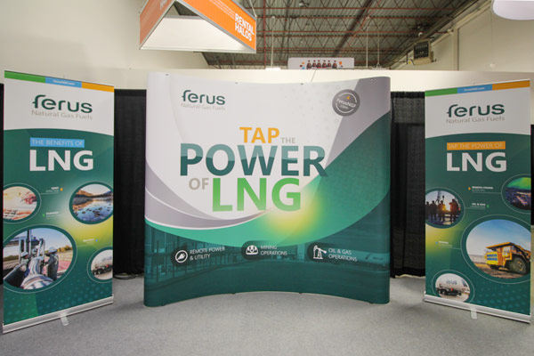 curved 8ft pop-up display for a natural gas company in Alberta. On each side is a 4tf-wide retractable banner stand. Bright green geometric graphics are used, along with circular images showcasing worksite equipment and locations.