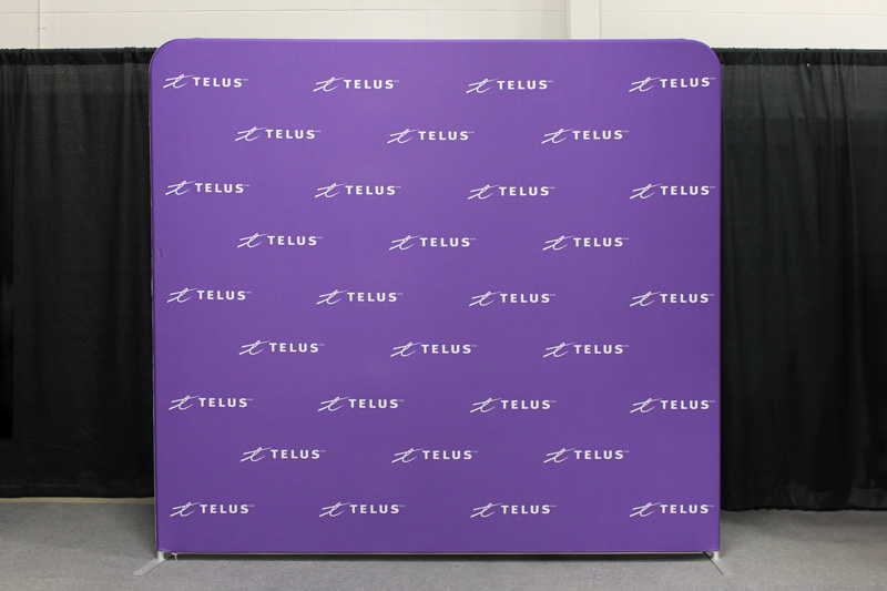 purple 8ft fabric wall with the telus logo pattern 