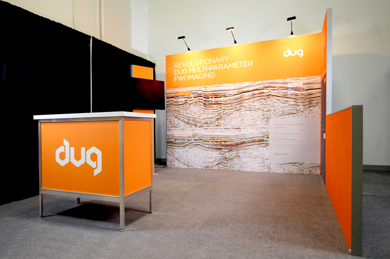 10x10 modular trade show display showing underground imaging graphics with orange accents and overhead lighting. 