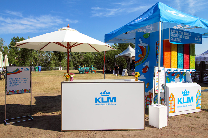 outdoor experiential marketing brand activation featuring a custom candy dispenser, branded counter, and outdoor signage.