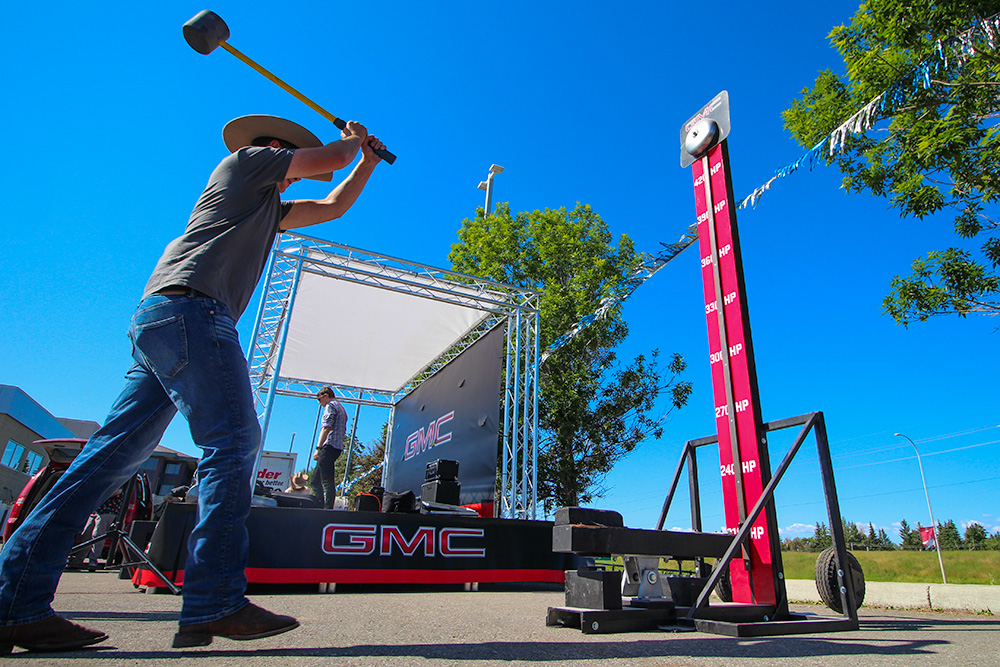 high striker game being played for a calgary stampede event