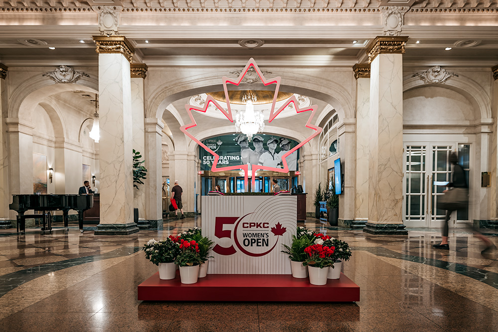 custom marketing display for a reception lobby in Calgary, Alberta. A large LED Maple leaf display is fixated on a box and platform, with branding for a women's golf championship. 