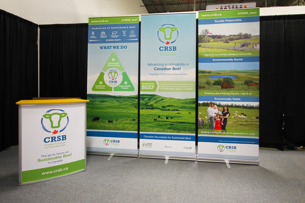 set of 3 portable retractable banner stands and a portable octanorm podium for trade shows and events in Calgary, Alberta.