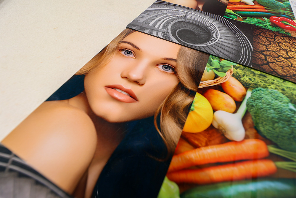 dye sublimated aluminum panel showing a headshot of a woman, a spiral staircase, and variety of vegetables in vidi colour