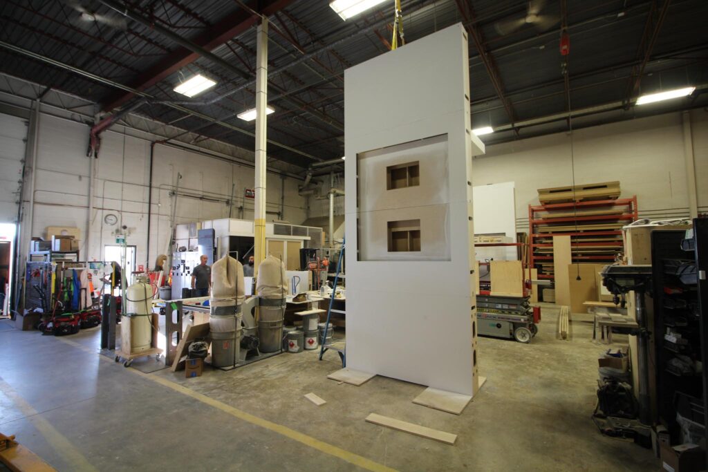 shape20x20_customFabrication a 16-ft tall tower being constructed to hold built-in tv monitors for a custom 20x20 trade show display in a shop in Calgary.